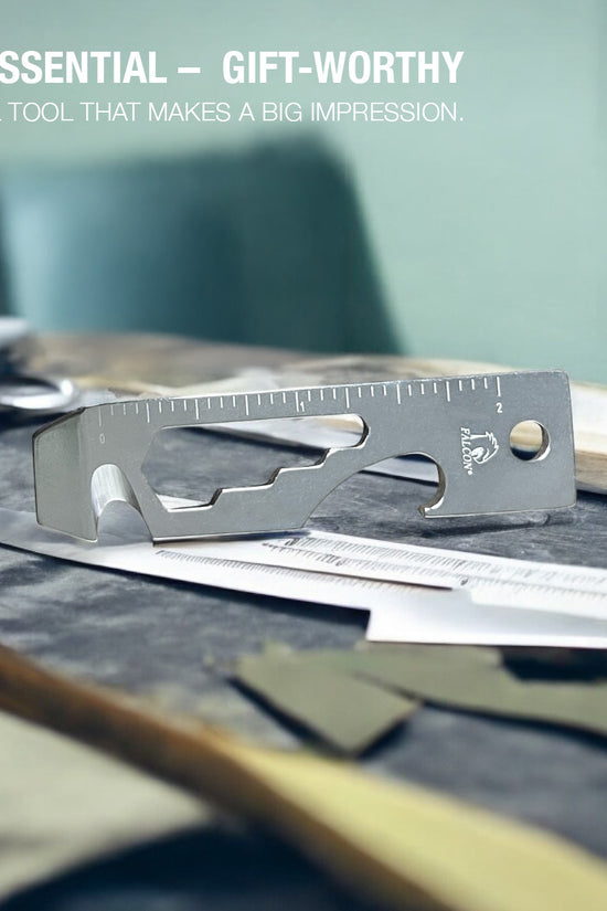 Falcon keychain multitool for outdoor use with ruler and bottle opener on a workbench