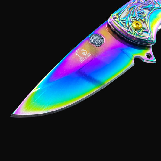 Close-up of Falcon Knives Rainbow Eagle and Ornate Spring Assisted Knife blade with vibrant rainbow finish and detailed handle