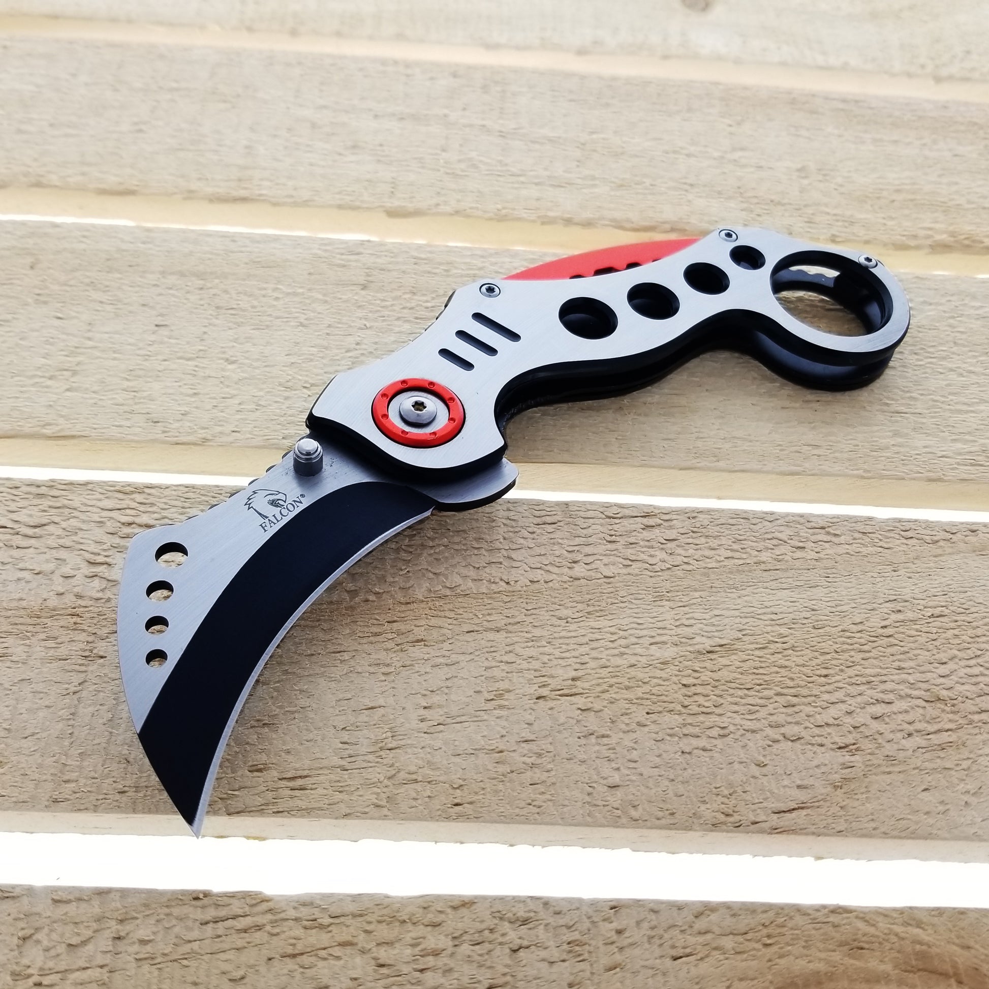 Falcon Red Karambit Spring Assisted Knife with a sleek design and black blade for easy use
