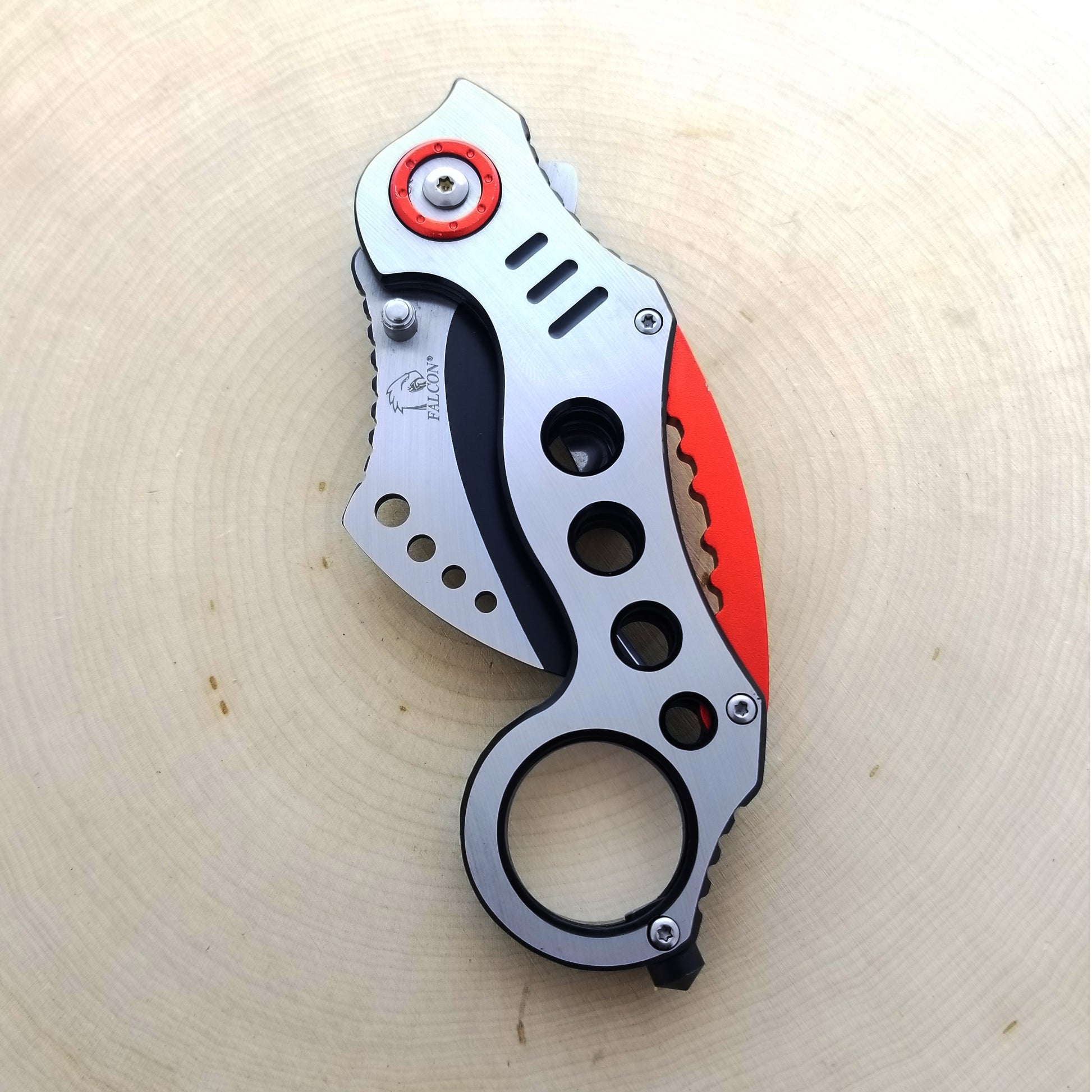 Falcon Red Karambit Spring Assisted Knife featuring a sleek design and functional grip for easy use