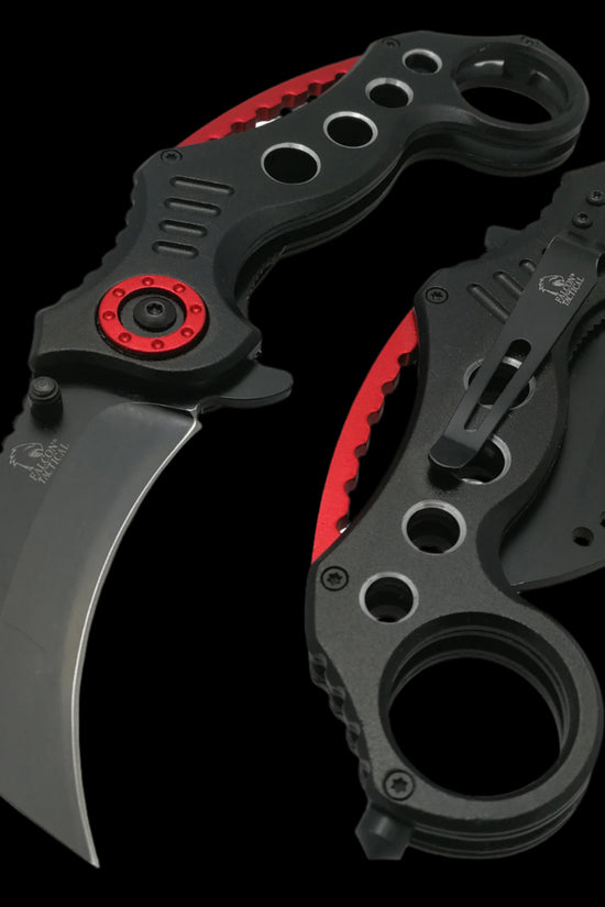 Falcon spring assisted karambit knife with black and red handle featuring ergonomic grip and curved blade