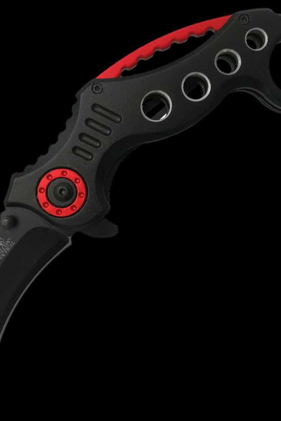 Falcon spring assisted karambit knife with black curved blade and black red perforated handle