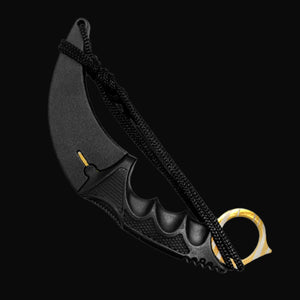 Black Falcon trainer karambit knife with curved blade and finger ring on black background