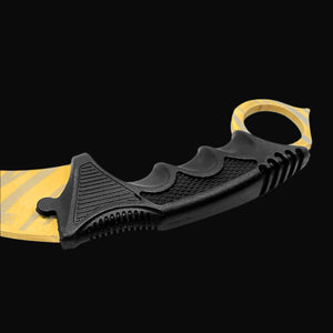 Black ergonomic handle of falcon trainer karambit knife with finger grooves and yellow blade
