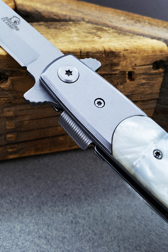 Falcon White Spring Assisted Pocket Knife with sleek silver blade and pearl handle for easy one-handed opening