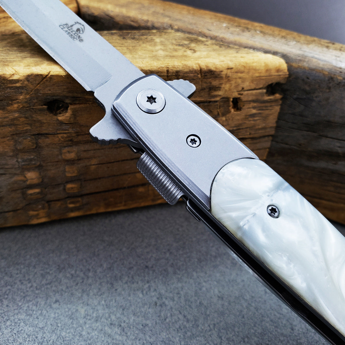 Falcon White Spring Assisted Pocket Knife with sleek silver blade and pearl handle for easy one-handed opening