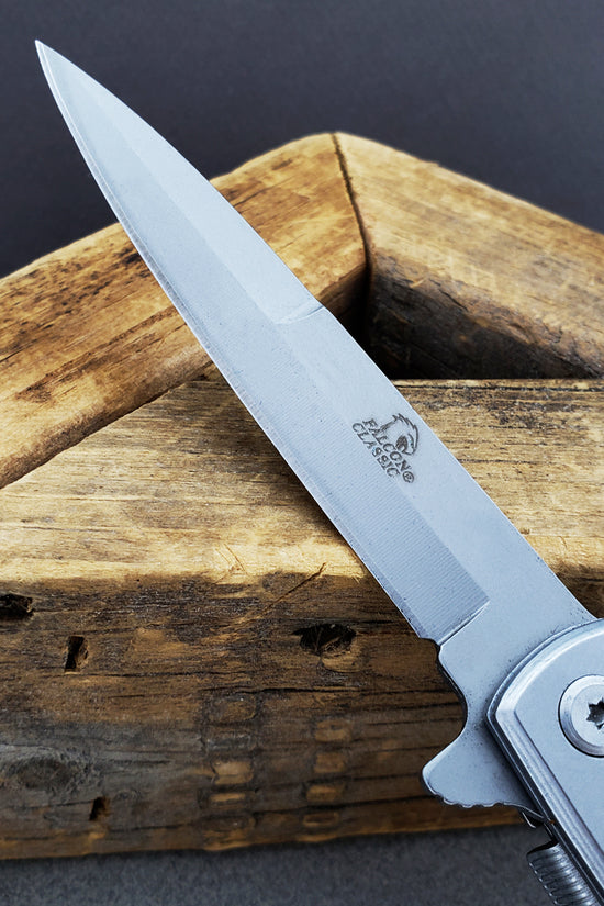 Falcon White Spring Assisted Pocket Knife with a sleek blade and ergonomic handle for easy use