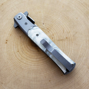 Falcon White Spring Assisted Pocket Knife with a sleek design and stainless steel blade