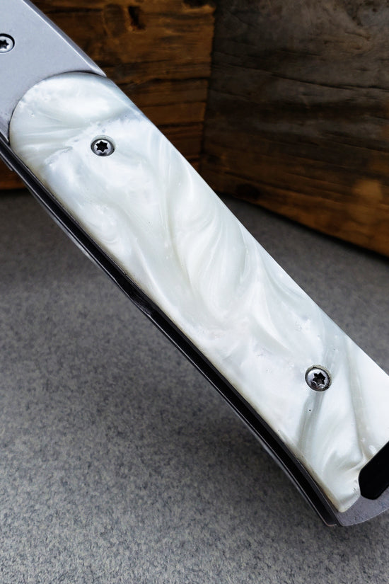 Falcon White Spring Assisted Pocket Knife with elegant white handle design and durable blade