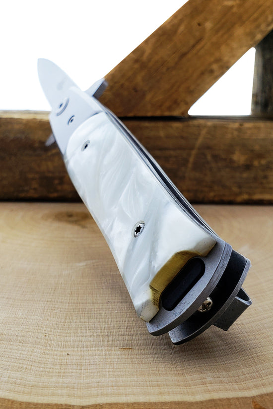 Falcon White Spring Assisted Pocket Knife with a sleek design and durable handle
