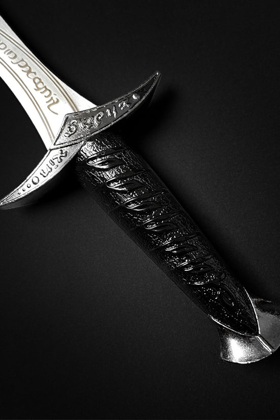 Guild Arms fantasy dagger for sale with engraved blade and textured black handle on black background