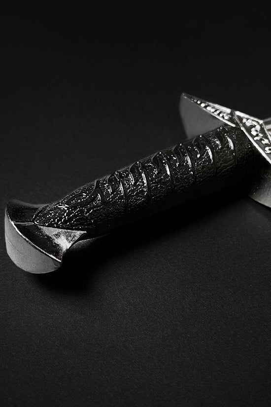 Guild Arms fantasy dagger for sale with detailed black handle and engraved silver guard on black background