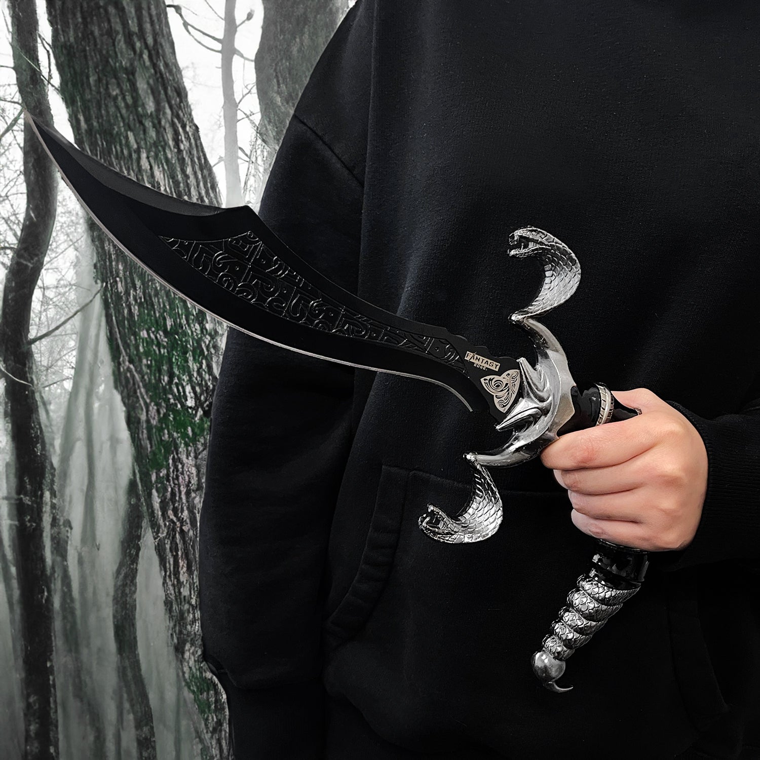 Fantasy Edge 12 Scorpion Dagger Curved Blade Scorpion Dagger W Stand held in hand against a dark forest backdrop