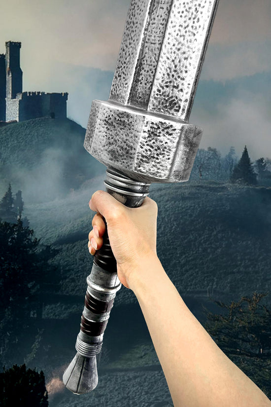 Guild Arms Foam Elden Sword held in hand against a castle backdrop for fantasy play