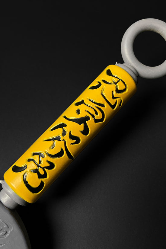 Otaku Gears foam flying thunder kunai with yellow handle and black Japanese characters on a black background