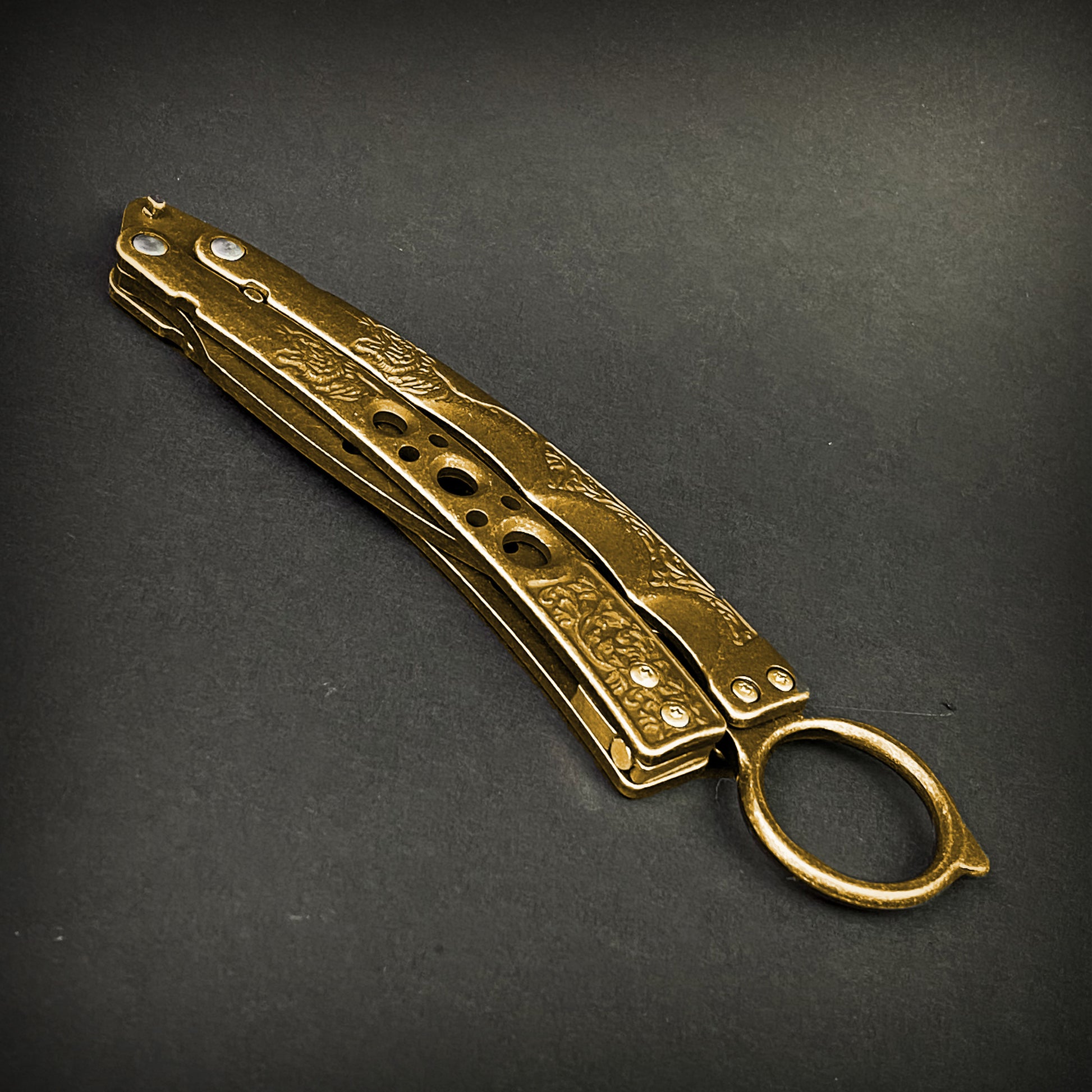 Gold butterfly trainer knife by Guild Arms with engraved handle and ring for practice