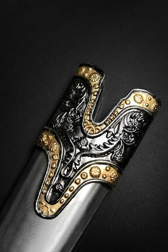 Fantasy Edge medieval Roman dagger with blue crystal styled ornate black and gold hilt showing embossed floral scrollwork