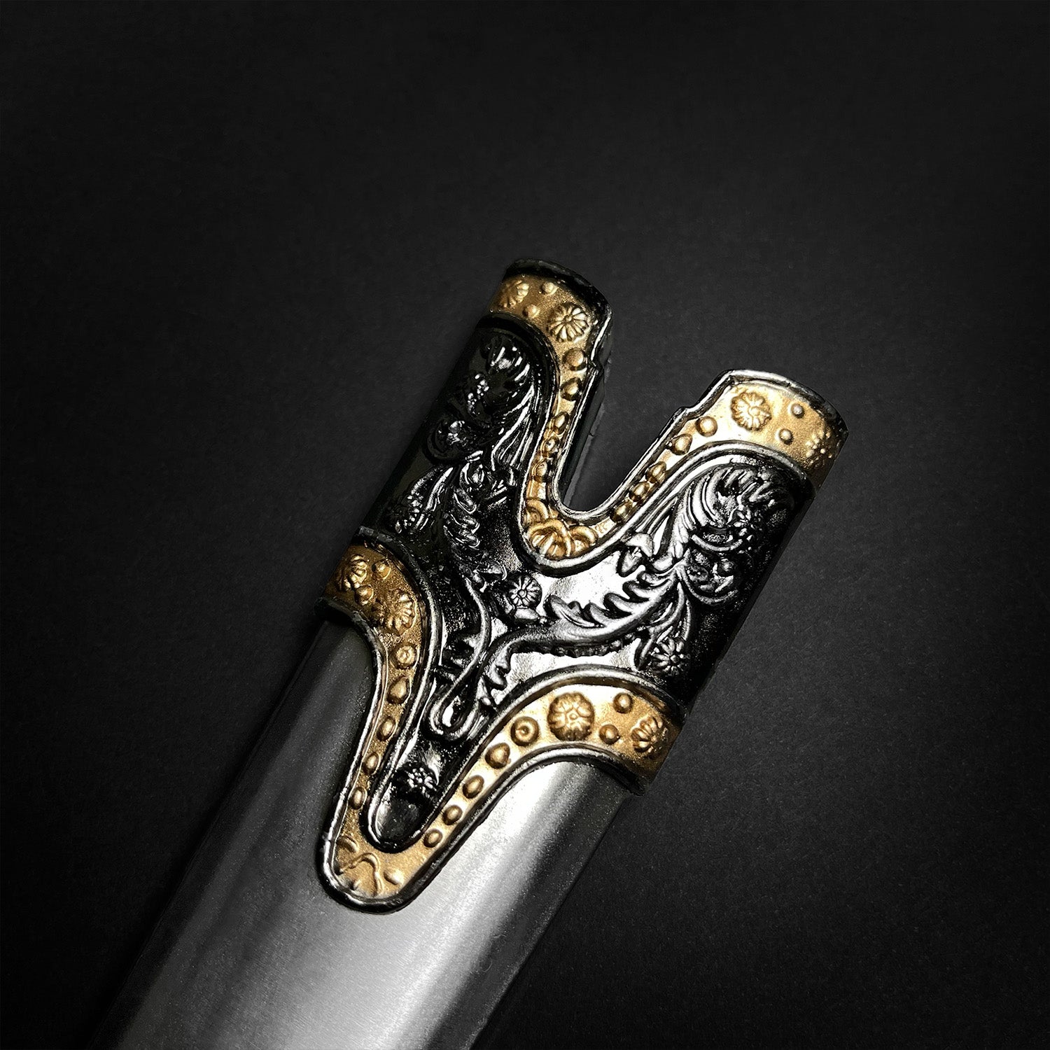 Fantasy Edge medieval Roman dagger with blue crystal styled ornate black and gold hilt showing embossed floral scrollwork