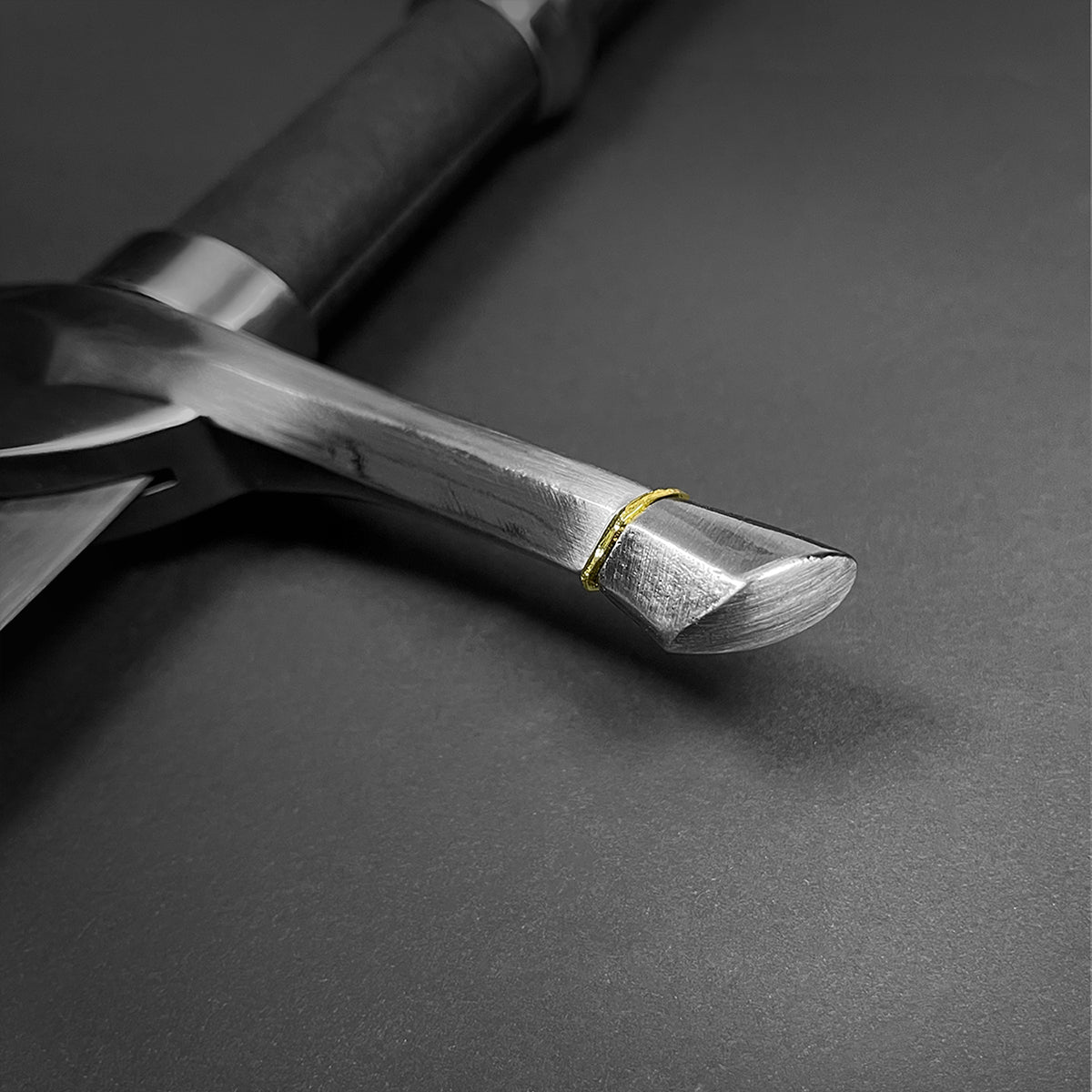 Close-up of Guild Arms medieval knight one hand sword for sale with polished steel blade and textured grip