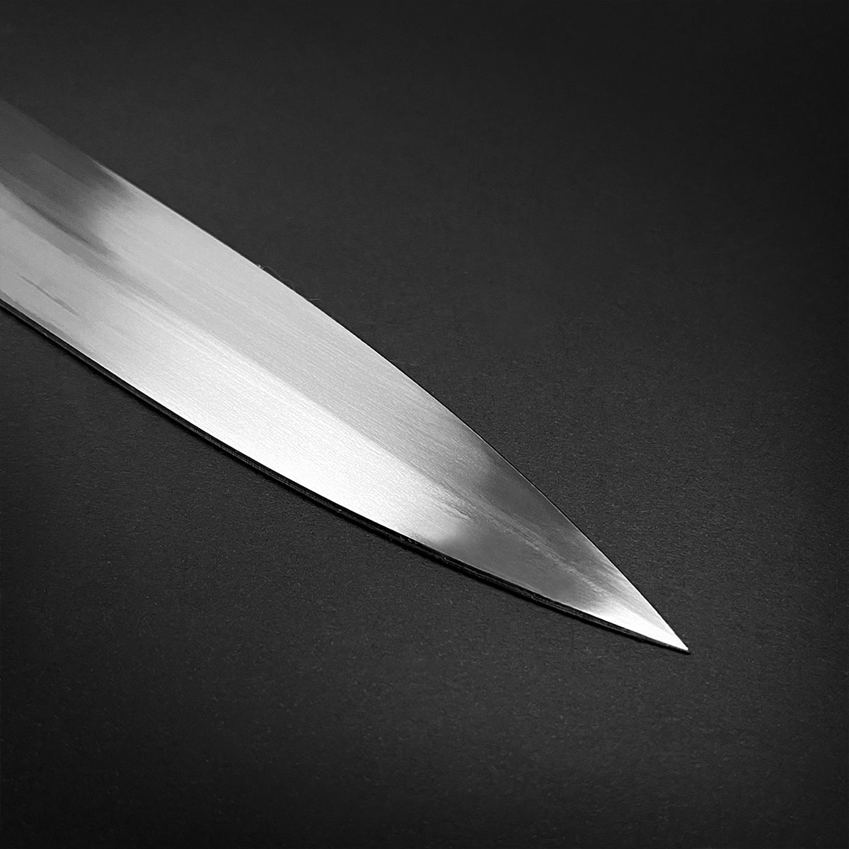 Close-up of a polished blade showcasing the edge of a medieval sword for sale by Guild Arms