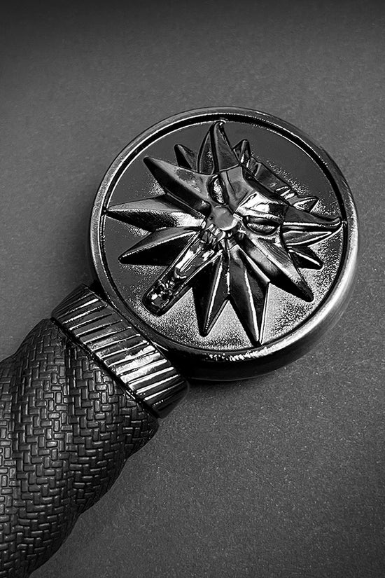 Close-up of a decorative handle on a medieval sword for sale by Guild Arms featuring an intricate design