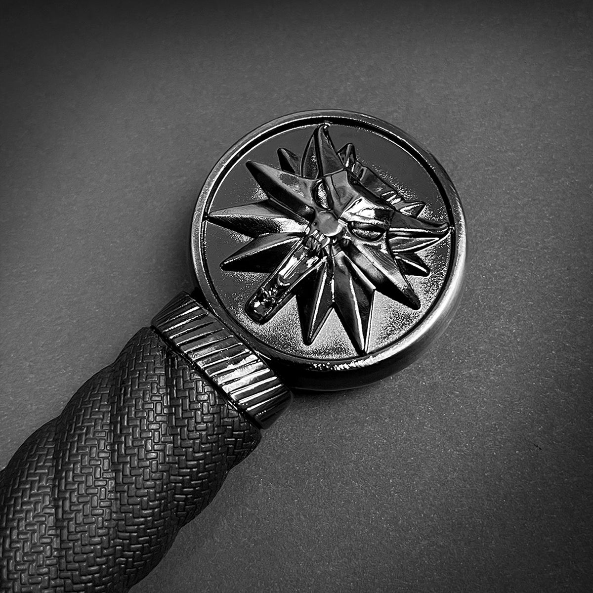 Close-up of a decorative handle on a medieval sword for sale by Guild Arms featuring an intricate design