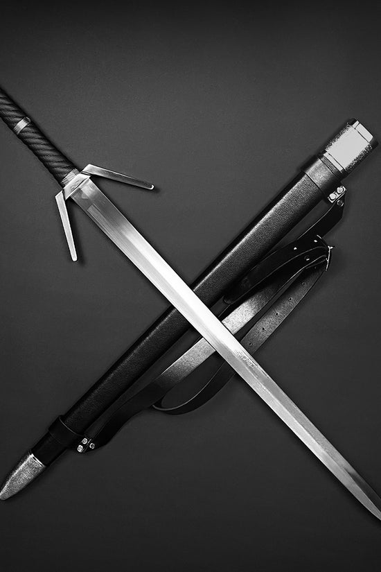 Guild Arms medieval sword for sale with a polished blade and ornate handle featuring a black sheath