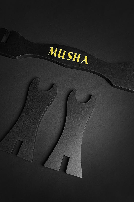 Musha Single Sword Display Stand featuring a sleek black design with gold lettering for elegant sword showcasing