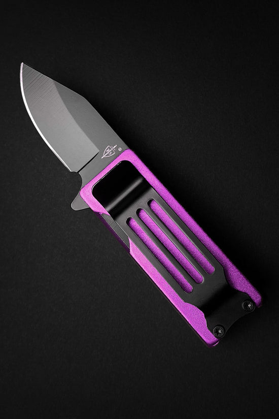Guild Arms lighter knife with purple handle and black knife lighter holder case on black background