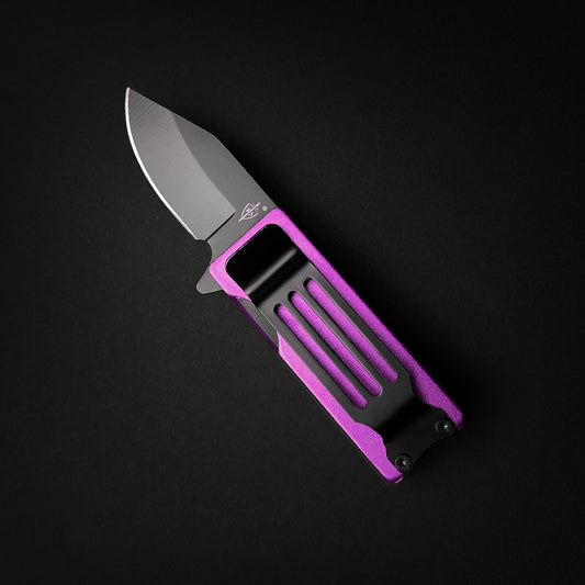 Guild Arms lighter knife with purple handle and black knife lighter holder case on black background