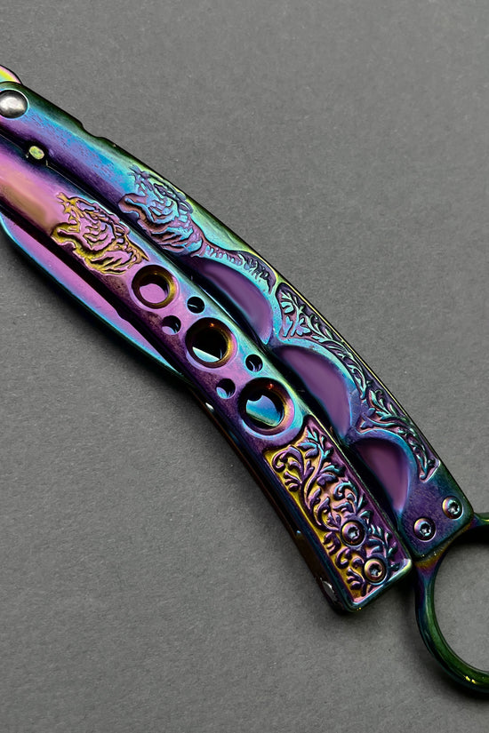 Guild Arms rainbow butterfly trainer knife with intricate engraved handle design on gray background
