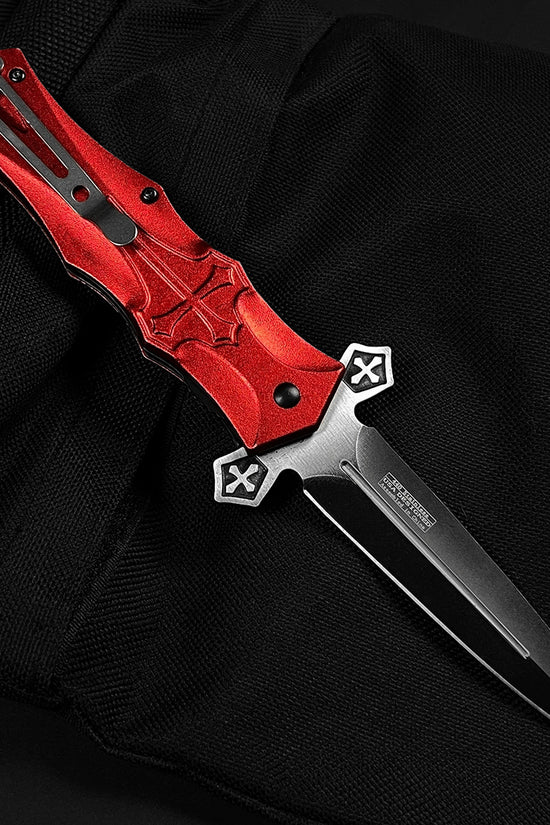 Guild Arms red cross handle spring pocket knife with a sleek black blade and ergonomic design