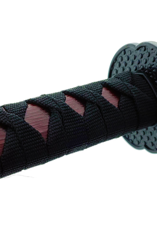 Close-up of a red wooden bokken samurai sword handle with intricate black wrap for enhanced grip