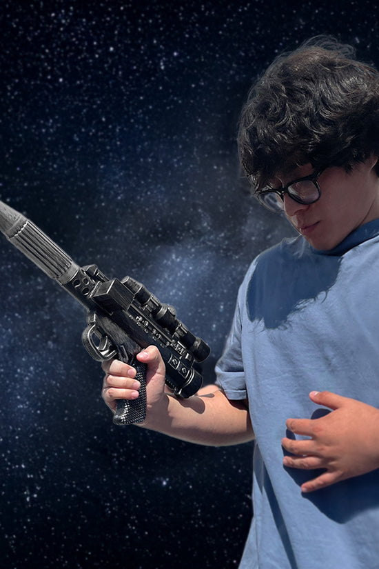 Guild Arms Sci-Fi Cosplay Foam Laser Gun featured with a person in a blue shirt against a cosmic background