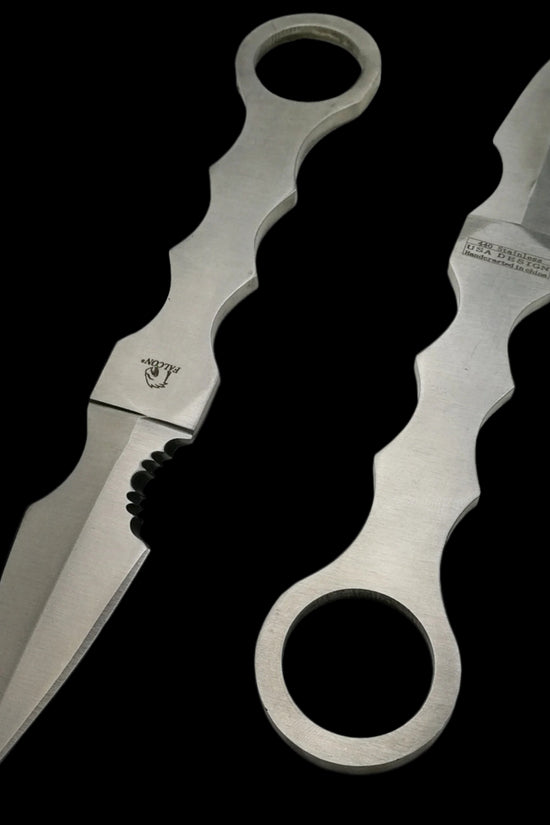 Falcon silver fixed blade tactical knife with ergonomic handle and sharp pointed blade on black background