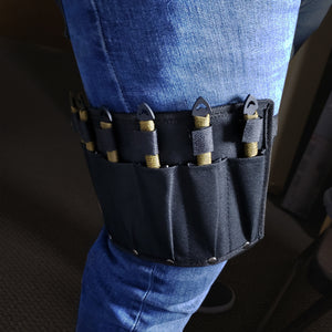 Target Master leg sheath with Falcon 6 PC throwing knives set strapped to thigh over blue jeans