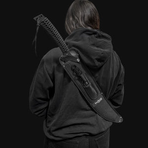 Tactical Master tactical machete with throwing knives in black sheath carried on back