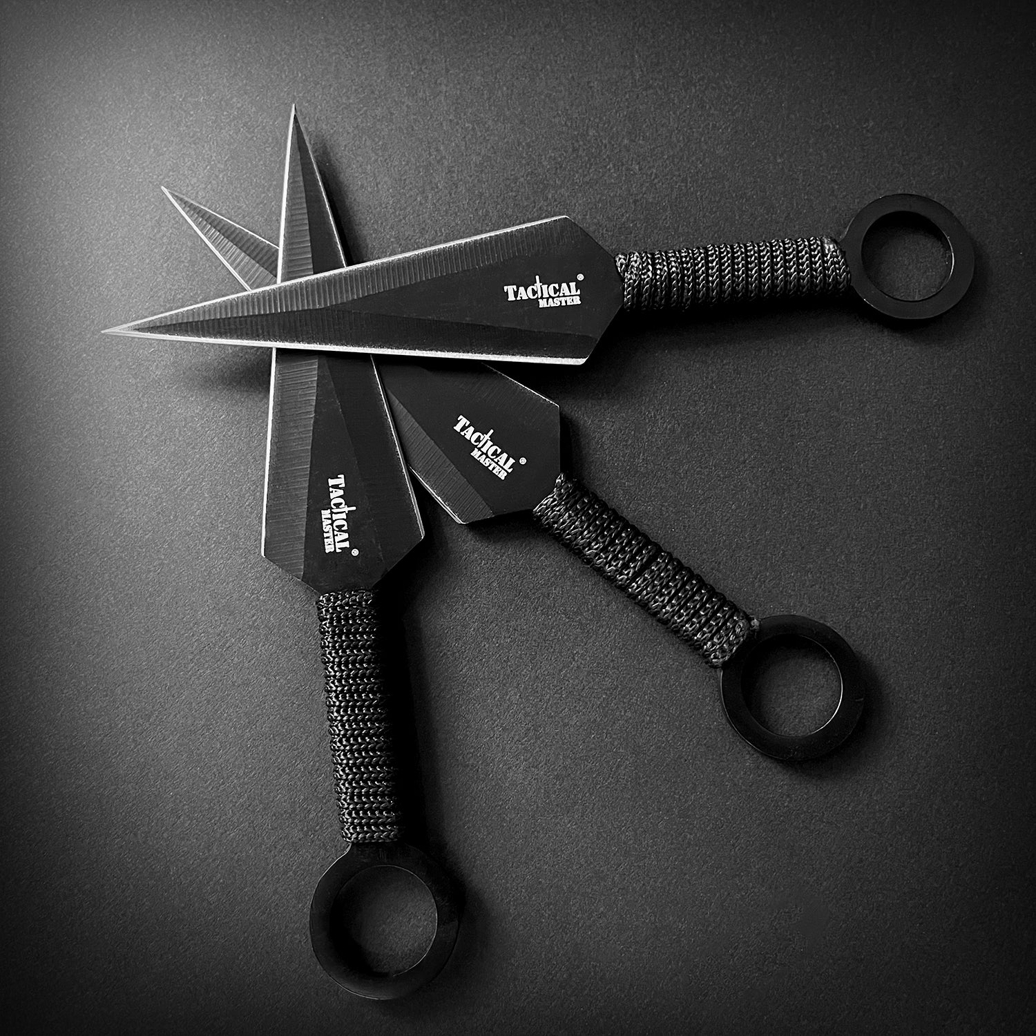 Tactical Master tactical machete with throwing knives set featuring black blades and wrapped handles