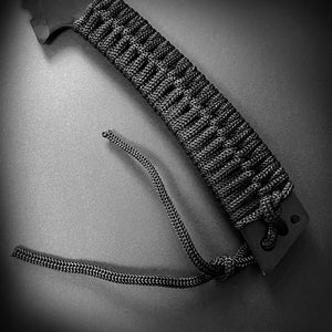 Close-up of Tactical Master tactical machete with throwing knives black braided handle grip