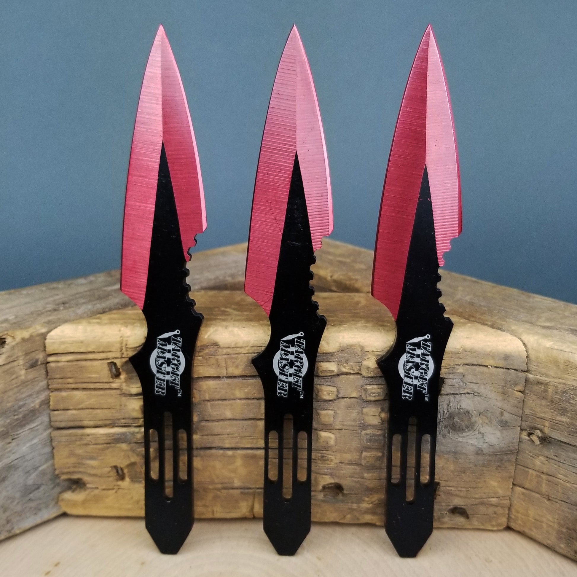 Red throwing knives set by Target Master with a sleek design and sharp edges for precision throwing