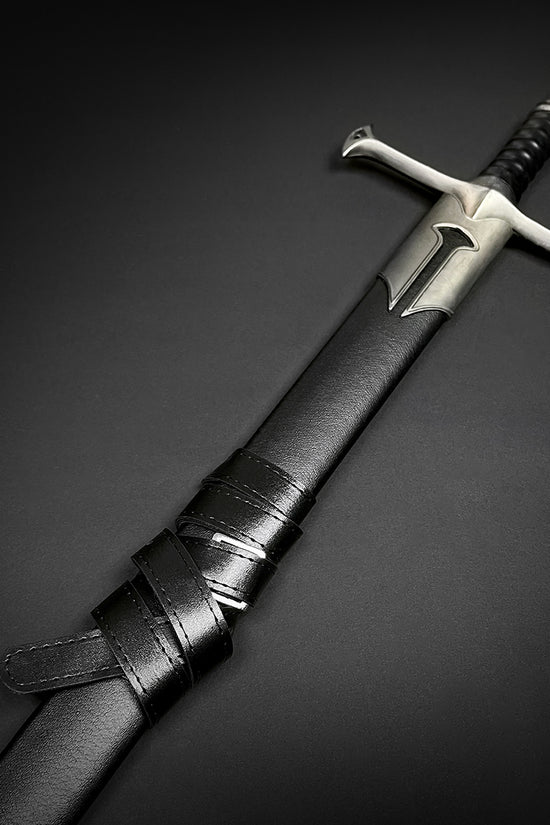 Guild Arms collectible medieval sword replica with black leather sheath and steel crossguard on black background