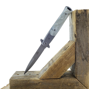 Falcon White Spring Assisted Pocket Knife with sleek design and durable materials on a wooden surface